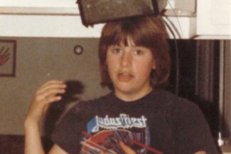 A younger Molly wearing a toaster on her head in a playful, surreal pose, symbolizing humor as a creative coping mechanism for addressing childhood trauma.