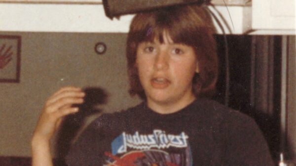 A younger Molly wearing a toaster on her head in a playful, surreal pose, symbolizing humor as a creative coping mechanism for addressing childhood trauma.
